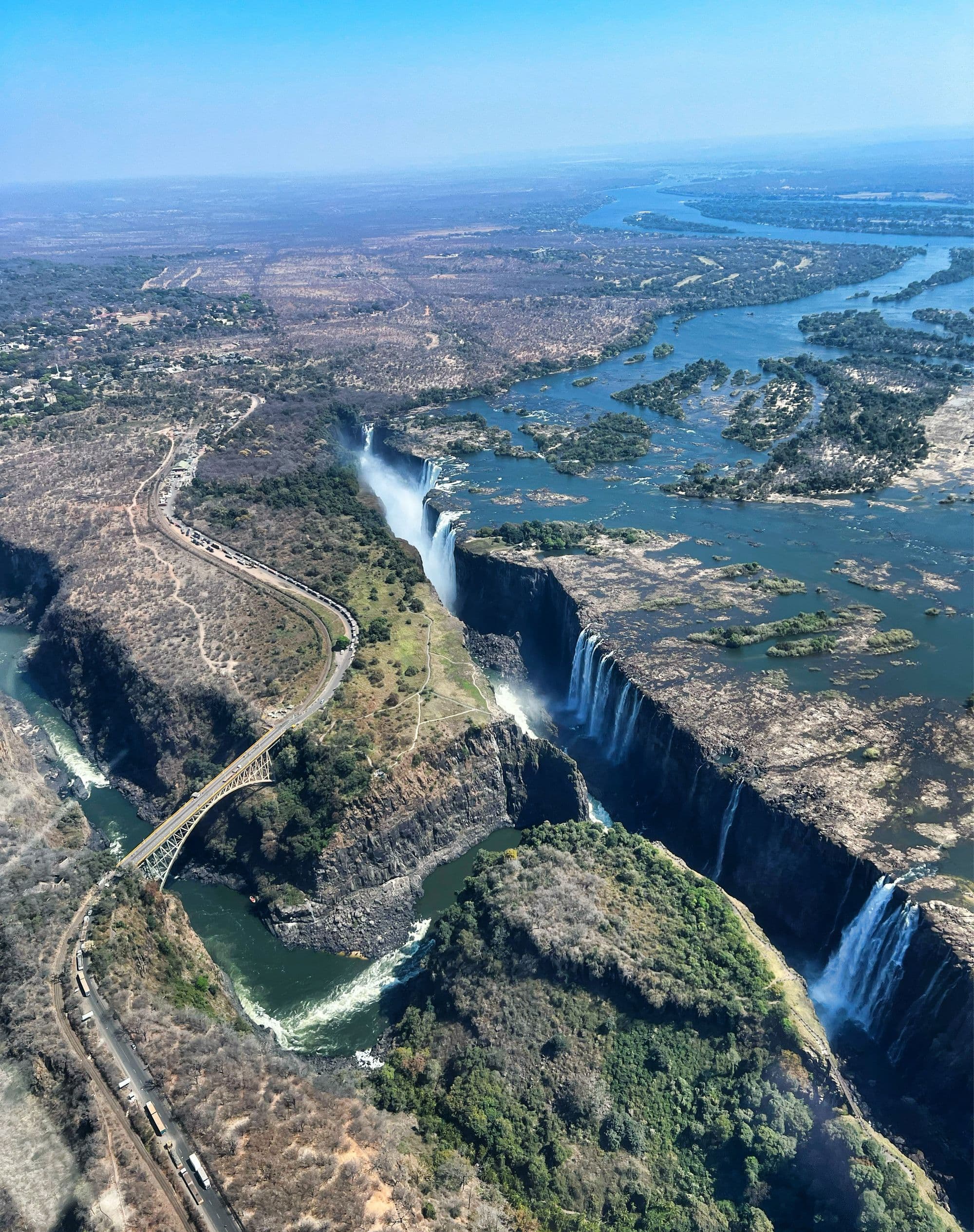 Aerial view of Victoria Falls on the Zambezi, with the gorge, spray, and the Victoria Falls Bridge